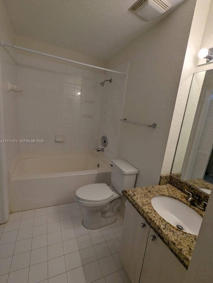 1801 N Flagler Drive, #912, West Palm Beach, West Palm Beach, FL 33401 Bathroom featuring a stone-look countertop vanity, an integrated oval sink, a shower-tub combination with white tile surround, and neutral floor tile