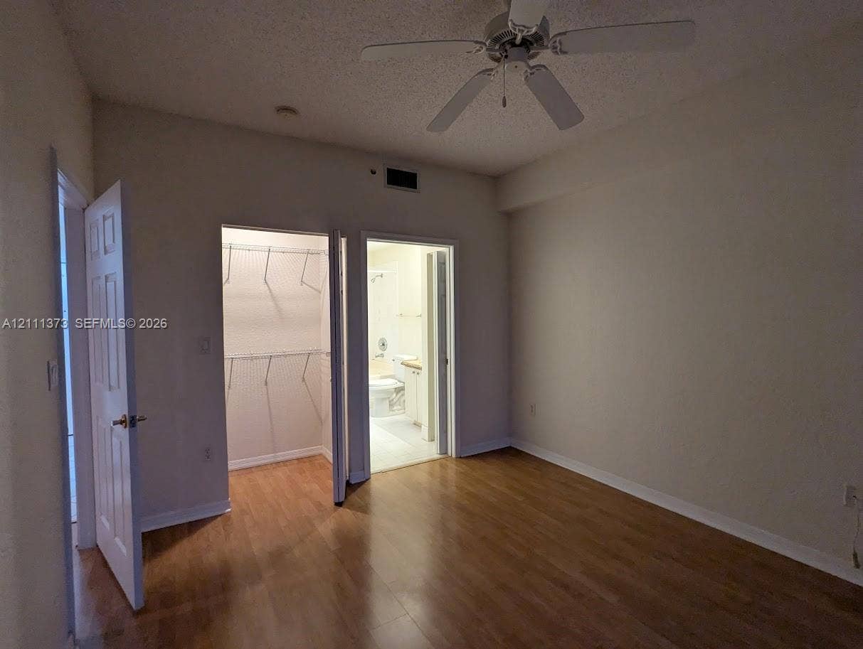 1801 N Flagler Drive, #912, West Palm Beach, West Palm Beach, FL 33401 Wood-finish flooring, ceiling fan with integrated lighting, reach-in closet with wire shelving, and interior panel doors