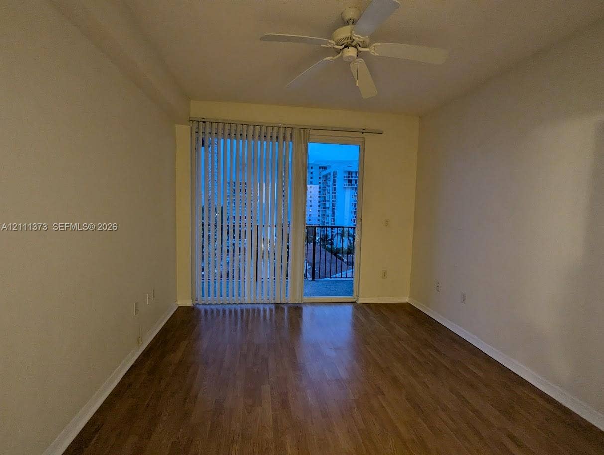1801 N Flagler Drive, #912, West Palm Beach, West Palm Beach, FL 33401 Interior space featuring wood-finish flooring, a ceiling fan with integrated light fixture, and floor-to-ceiling glass sliding doors opening to a balcony