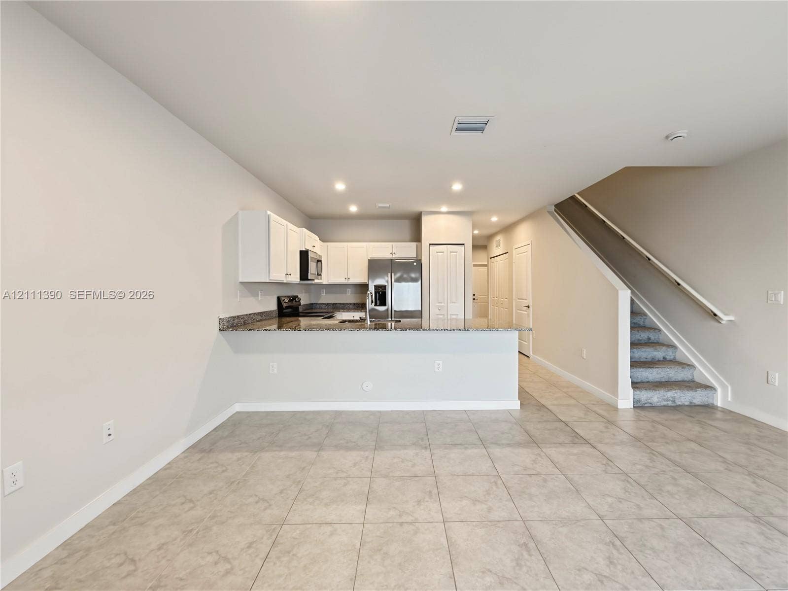 1074 NW 6th Terrace, Florida City, Florida City, FL 33034 Kitchen featuring white cabinetry, stone-finish countertops, stainless steel refrigerator, recessed lighting, and tile flooring
