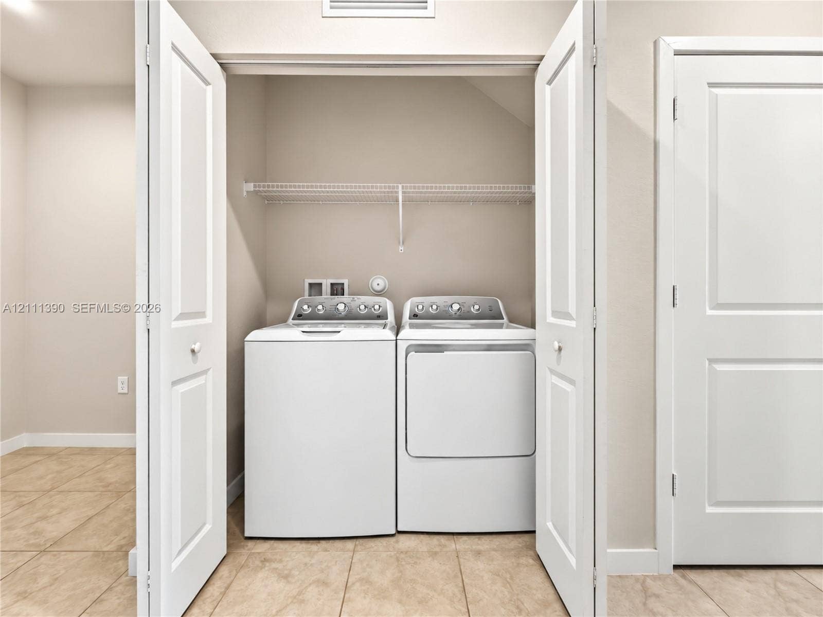 1074 NW 6th Terrace, Florida City, Florida City, FL 33034 Laundry closet featuring double panel doors, wire shelving, and tile flooring