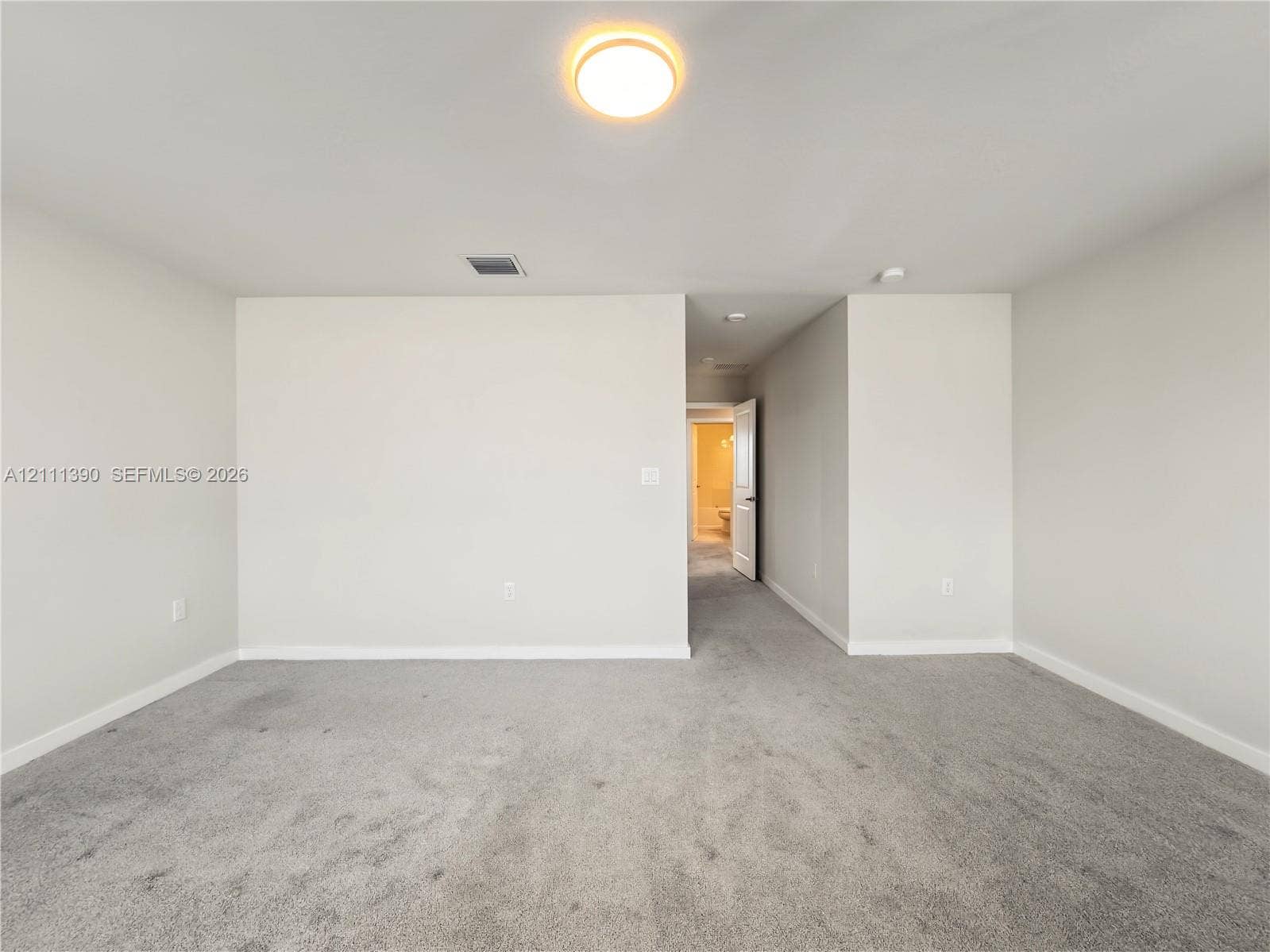 1074 NW 6th Terrace, Florida City, Florida City, FL 33034 Neutral-toned interior room featuring wall-to-wall carpeting and a ceiling-mounted light fixture