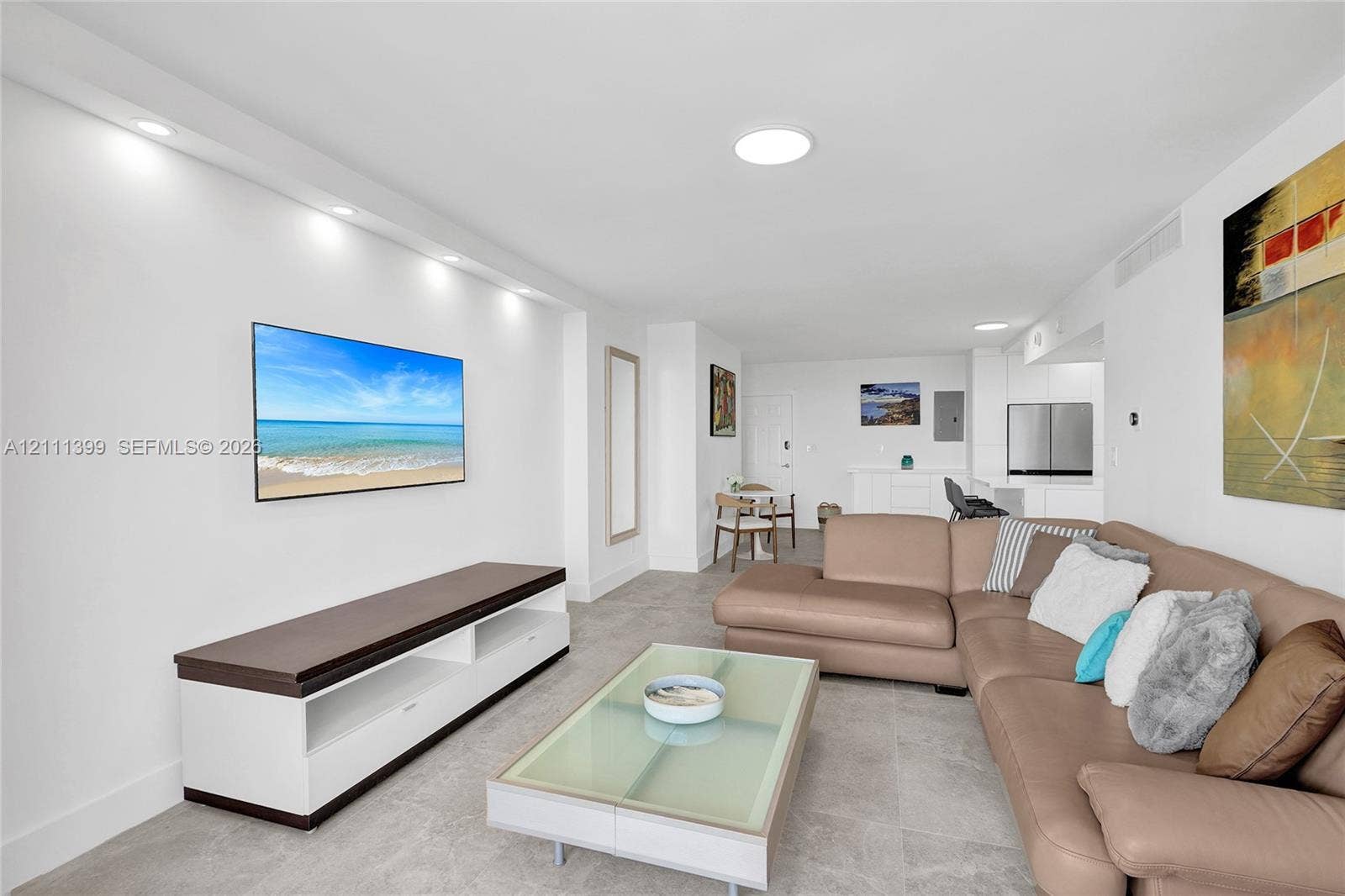 2501 S Ocean Drive, #1630, Hollywood, Hollywood, FL 33019 Open-concept living area featuring light-toned tile flooring, recessed ceiling lighting, and a custom built-in media console with storage