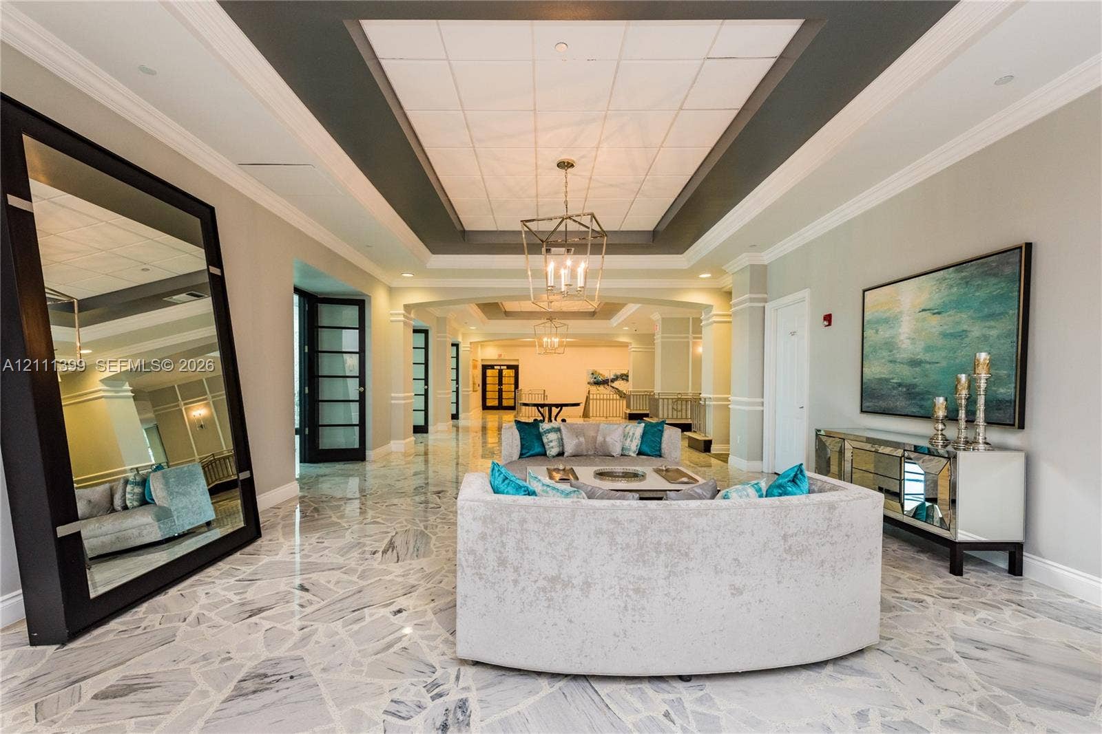 2501 S Ocean Drive, #1630, Hollywood, Hollywood, FL 33019 Expansive foyer featuring polished stone flooring with a mosaic pattern, coffered ceilings, crown molding, and metal lantern-style chandeliers