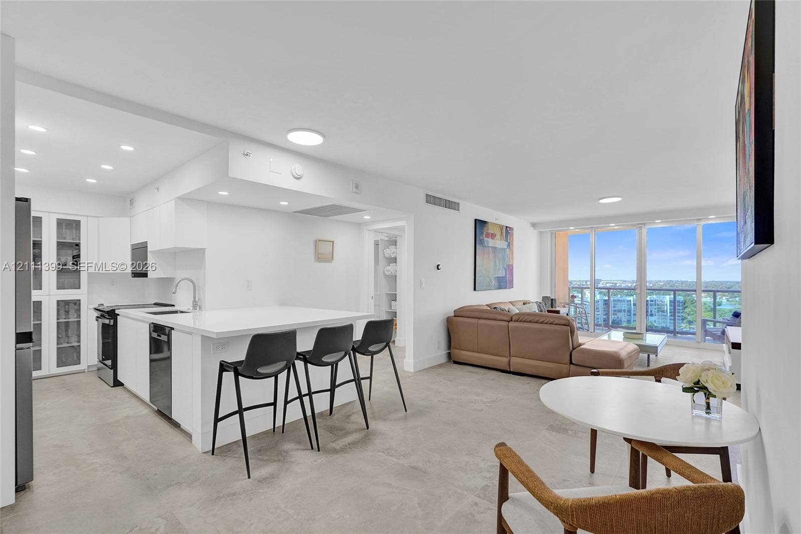 2501 S Ocean Drive, #1630, Hollywood, Hollywood, FL 33019 Living area featuring tile flooring, recessed ceiling lighting, and floor-to-ceiling glass sliding doors opening to a balcony with metal railings