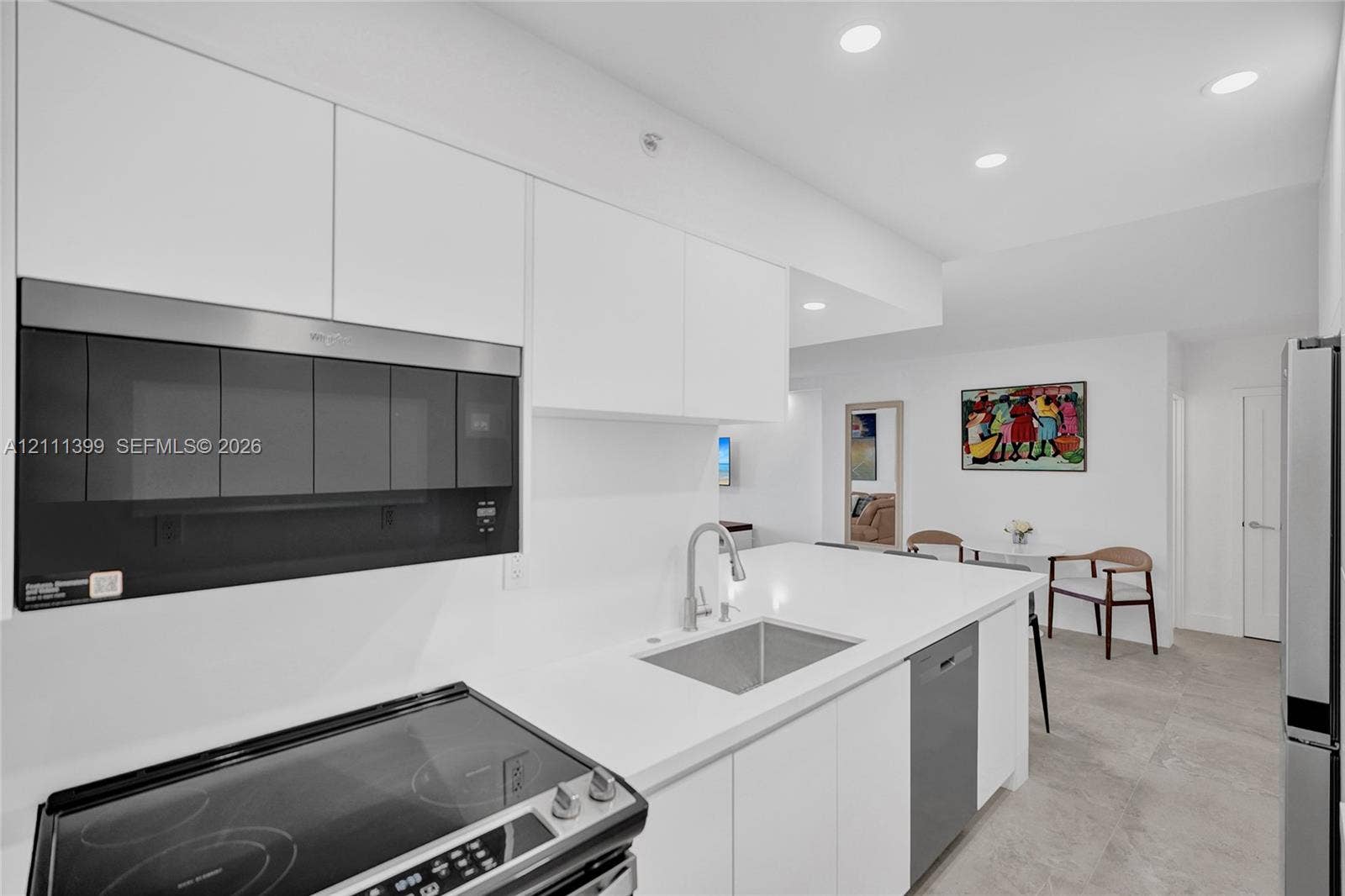2501 S Ocean Drive, #1630, Hollywood, Hollywood, FL 33019 Kitchen featuring flat-panel white cabinetry, solid surface countertops, stainless steel appliances, an undermount sink with a gooseneck faucet, and recessed lighting