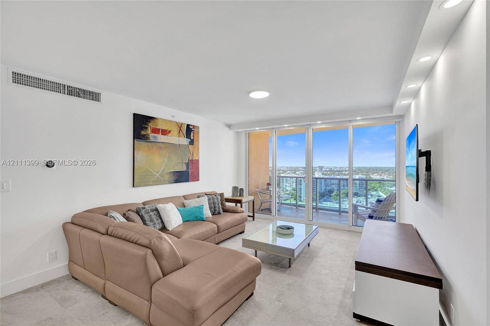 2501 S Ocean Drive, #1630, Hollywood, Hollywood, FL 33019 Living area featuring tile flooring, recessed ceiling lighting, and floor-to-ceiling glass sliding doors opening to a balcony with metal railings