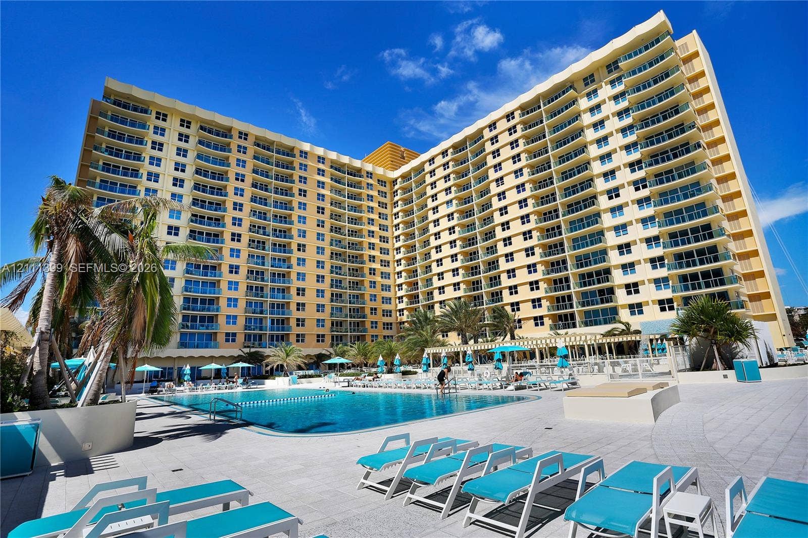 2501 S Ocean Drive, #1630, Hollywood, Hollywood, FL 33019 High-rise condominium building featuring tiered private balconies, an expansive outdoor swimming pool, and stone-paved sun deck