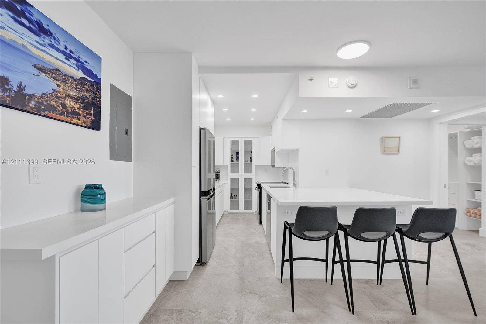 2501 S Ocean Drive, #1630, Hollywood, Hollywood, FL 33019 Kitchen featuring white flat-panel cabinetry, stone countertops, stainless steel refrigerator, glass-front upper cabinet, and recessed ceiling lighting