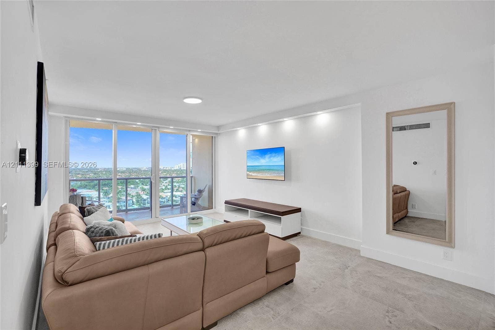 2501 S Ocean Drive, #1630, Hollywood, Hollywood, FL 33019 Living area featuring neutral stone flooring, floor-to-ceiling glass sliding doors, recessed lighting, and a private balcony with an expansive exterior outlook