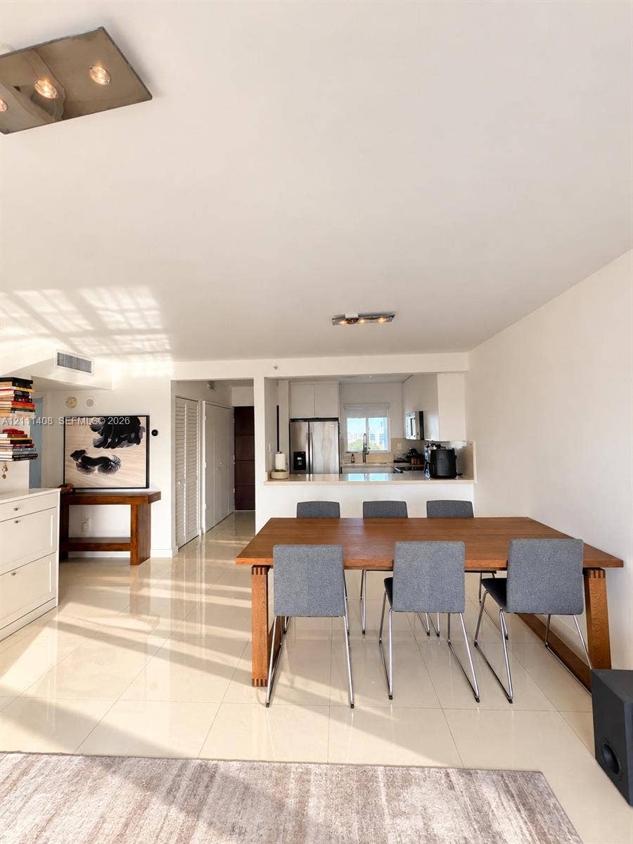1700 N River Drive, #1004, Miami, FL 33125 Floor-to-ceiling glass walls, polished tile flooring, balcony access, and minimalist overhead lighting