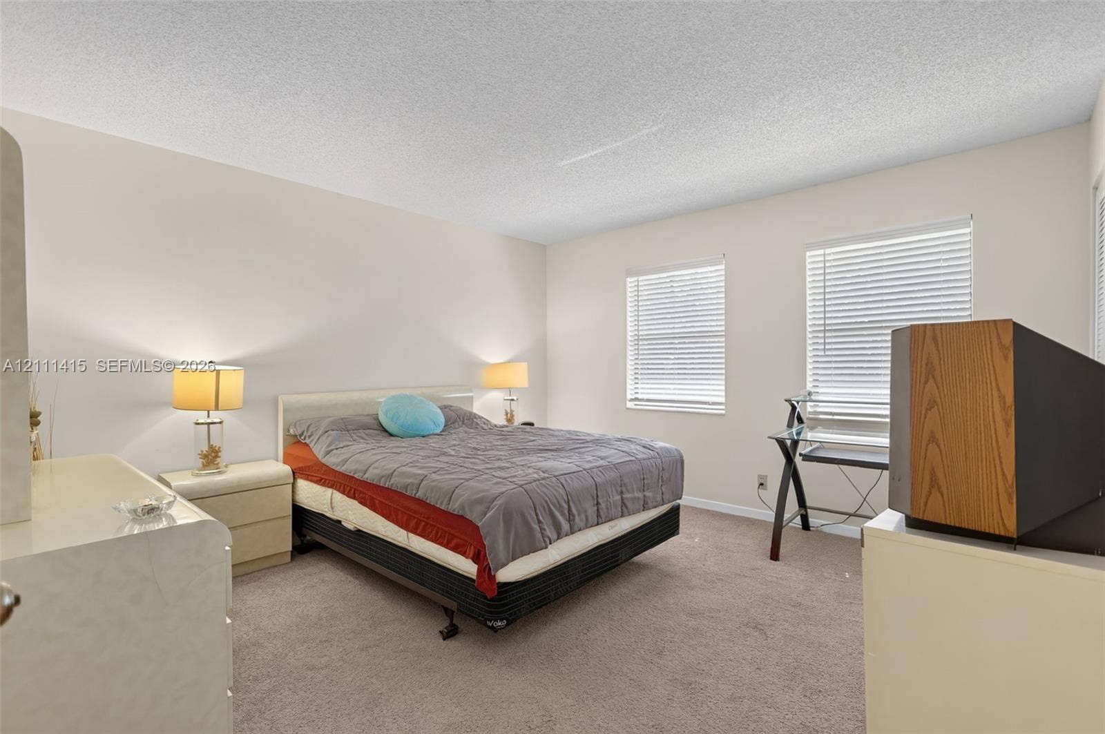 9423 S Ocean Drive, #80, Jensen Beach, FL 34957 Neutral-toned walls, wall-to-wall carpeting, and dual windows equipped with horizontal blinds