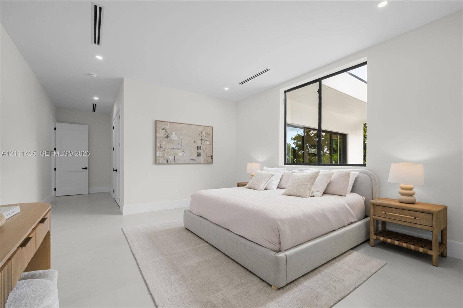 9530 SW 95th Court, Miami, FL 33176 Spacious room featuring high ceilings, recessed lighting, expansive large-format windows with black frames, and smooth-finish flooring