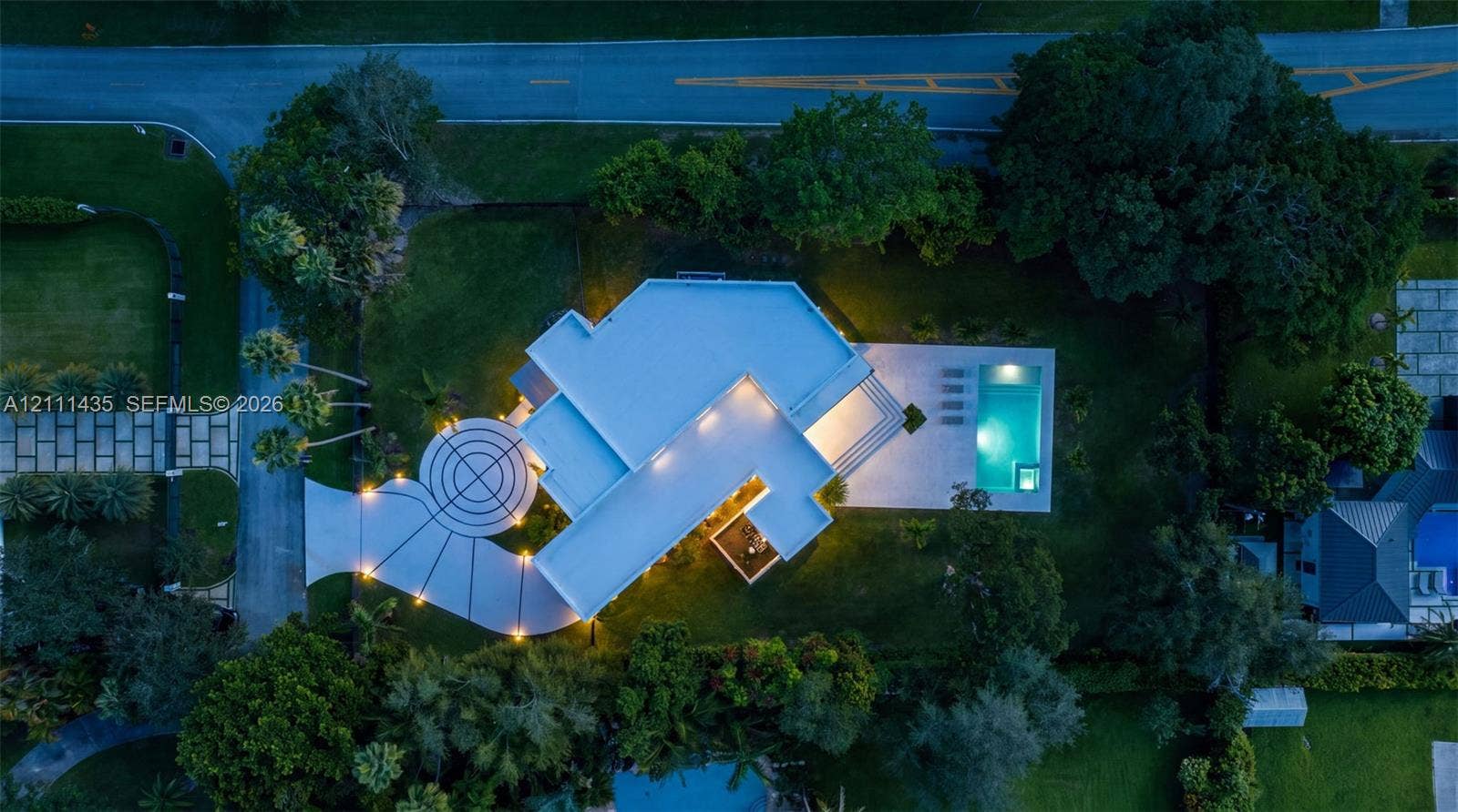 9530 SW 95th Court, Miami, FL 33176 Aerial view featuring a circular concrete driveway, expansive lawn, mature tree canopy, and a rectangular swimming pool with paved terrace