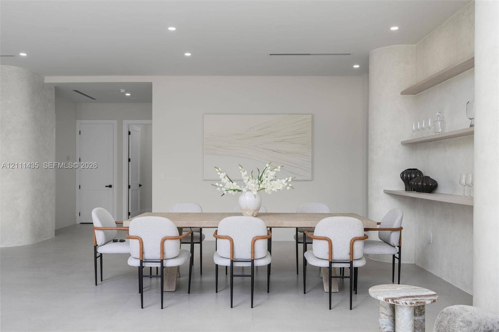 9530 SW 95th Court, Miami, FL 33176 Interior space featuring smooth plaster wall finishes, curved structural columns, integrated wall shelving, recessed ceiling lighting, and solid-core paneled doors