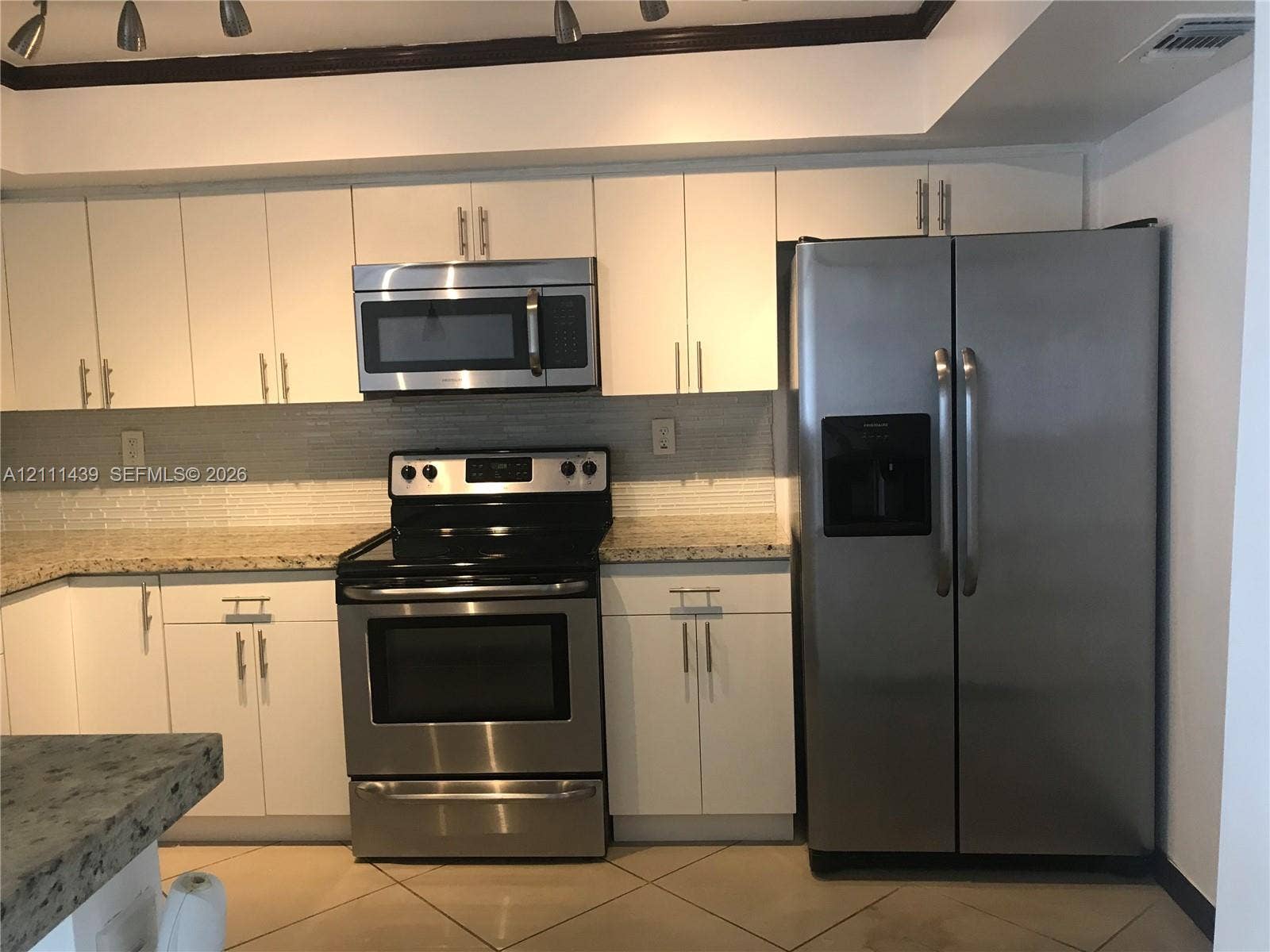 800 Parkview Drive, #102, Hallandale Beach, Hallandale Beach, FL 33009 Kitchen featuring white cabinetry, stone-surface countertops, light-colored tile flooring, and stainless steel appliances