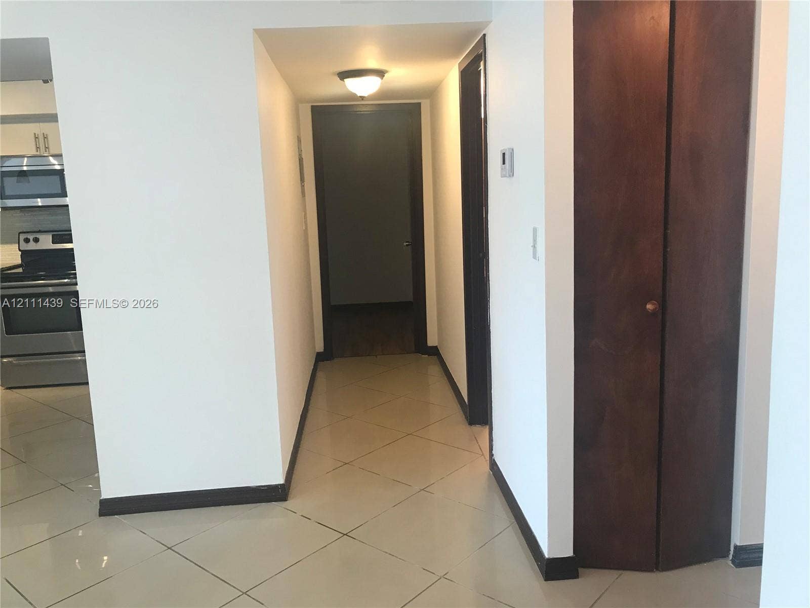 800 Parkview Drive, #102, Hallandale Beach, Hallandale Beach, FL 33009 Tile flooring, dark wood-finish bi-fold doors, and flush-mount lighting fixtures