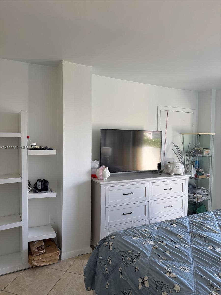 8255 Abbott Avenue, #402, Miami Beach, Miami Beach, FL 33141 Built-in white shelving unit and large-format tile flooring
