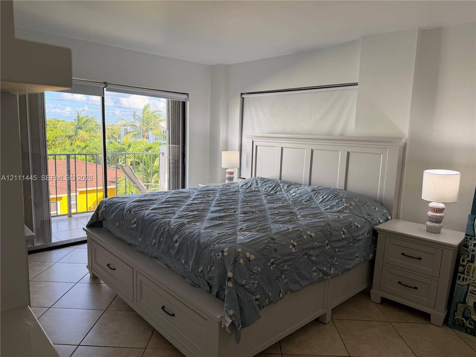 8255 Abbott Avenue, #402, Miami Beach, Miami Beach, FL 33141 Ceramic tile flooring, neutral wall tones, and glass sliding doors opening to a balcony