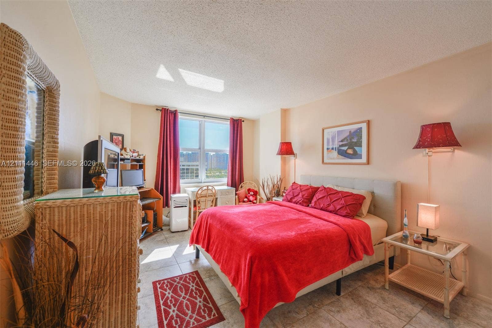 1965 S Ocean Drive, #15M, Hallandale Beach, Hallandale Beach, FL 33009 Bedroom featuring tile flooring, a large window providing natural light, and dual wall-mounted light fixtures
