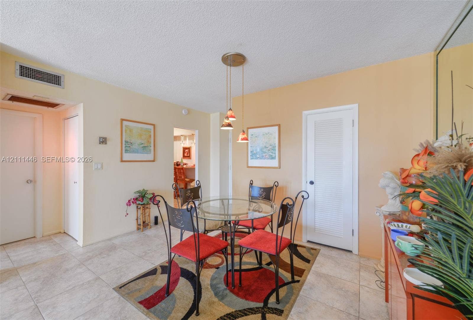 1965 S Ocean Drive, #15M, Hallandale Beach, Hallandale Beach, FL 33009 Neutral-toned tile flooring, three-light metal pendant fixture, and louvered door closet