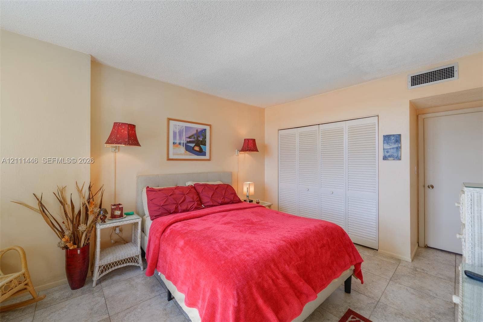 1965 S Ocean Drive, #15M, Hallandale Beach, Hallandale Beach, FL 33009 Neutral-toned room with stone-finish tile flooring and floor-to-ceiling closet featuring white louvered sliding doors