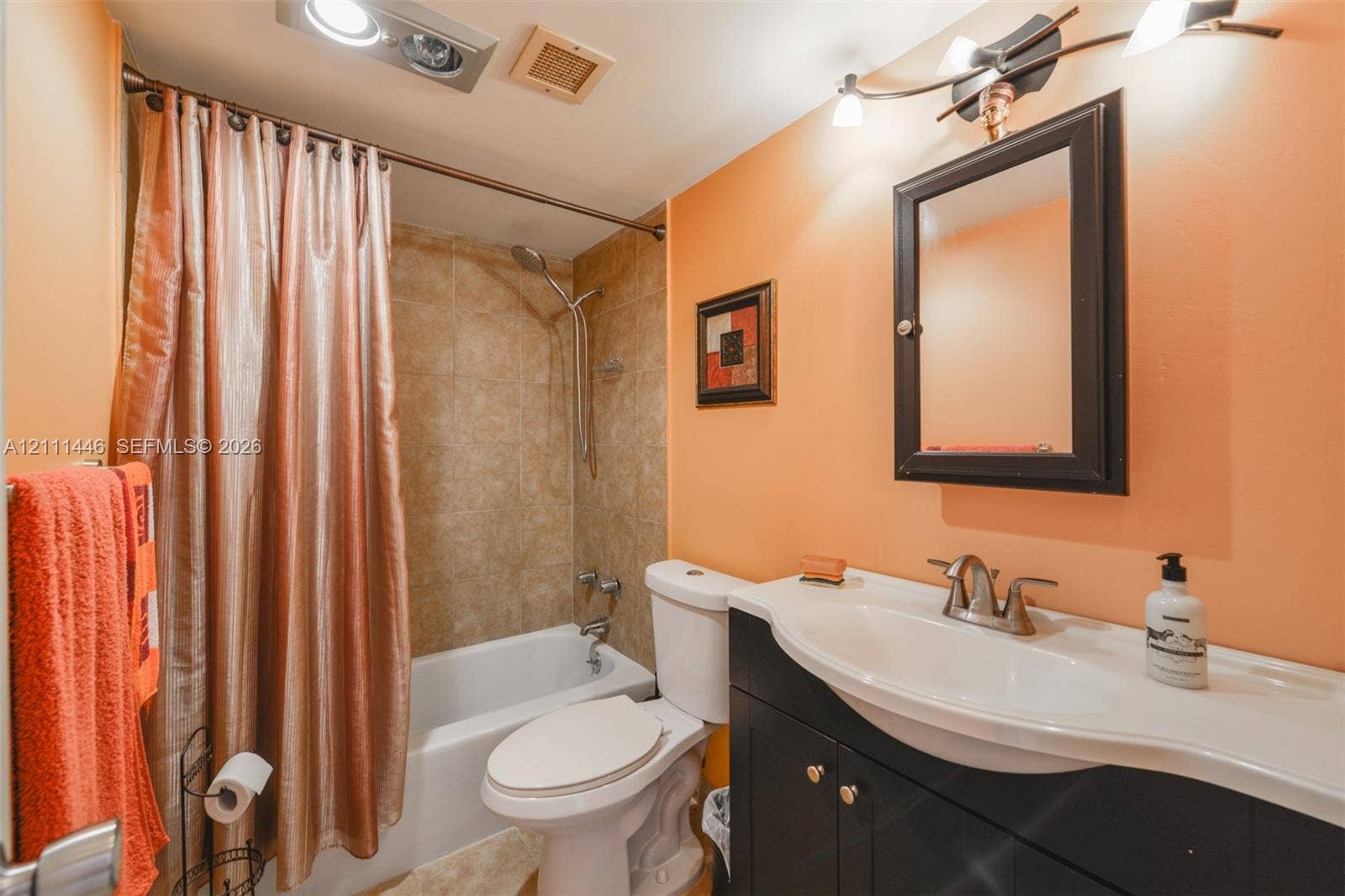 1965 S Ocean Drive, #15M, Hallandale Beach, Hallandale Beach, FL 33009 Bathroom featuring a dark wood-finish vanity with a molded countertop, integrated sink, wall-mounted medicine cabinet, and a shower-tub combination with tile surround