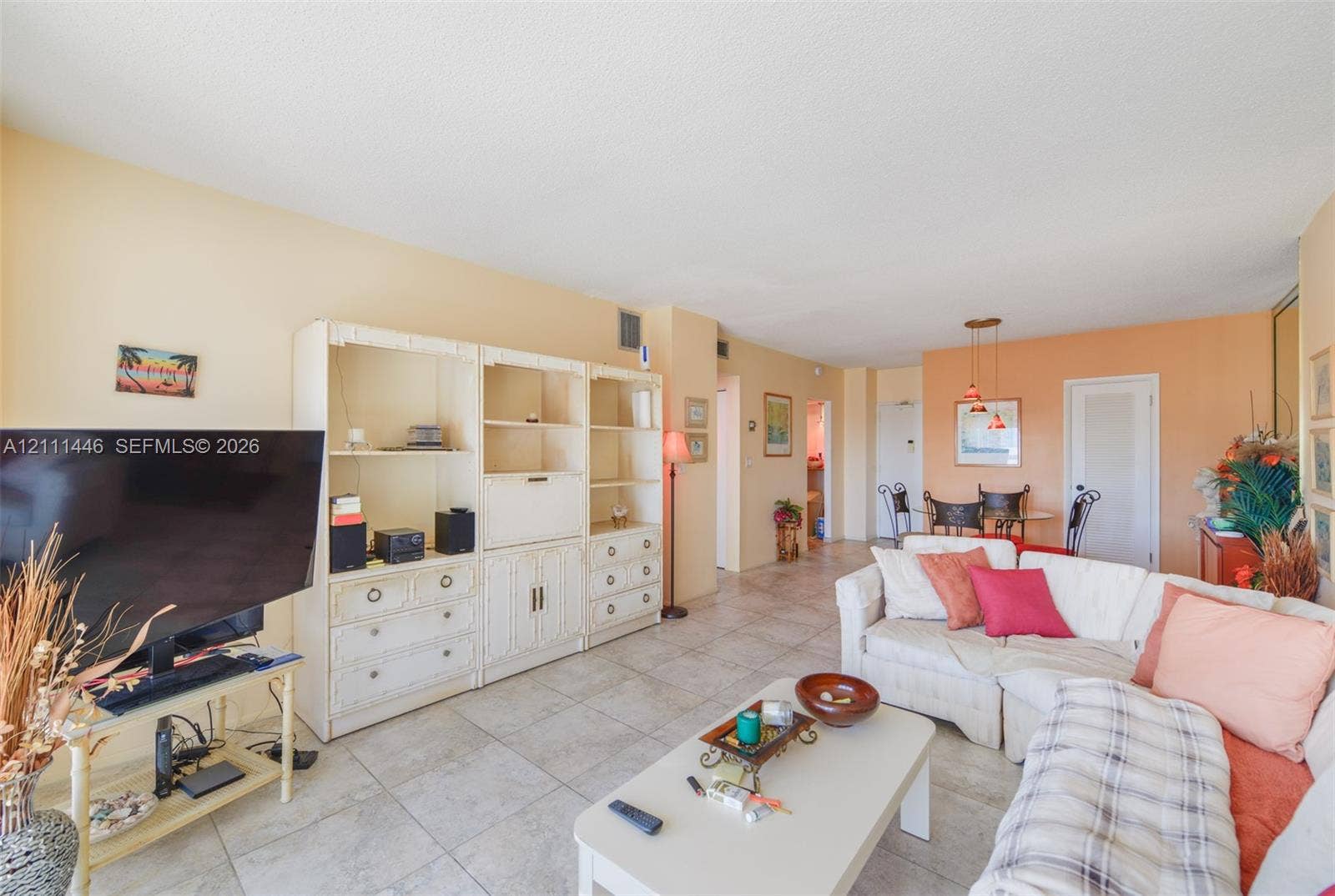 1965 S Ocean Drive, #15M, Hallandale Beach, Hallandale Beach, FL 33009 Living area featuring large-format ceramic tile flooring and floor-to-ceiling built-in shelving