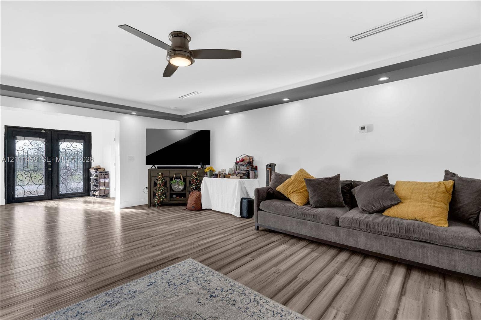 17135 NW 19th Avenue, Miami Gardens, FL 33056 Open-concept interior, tray ceiling with recessed lighting, and double entry doors with decorative iron detailing
