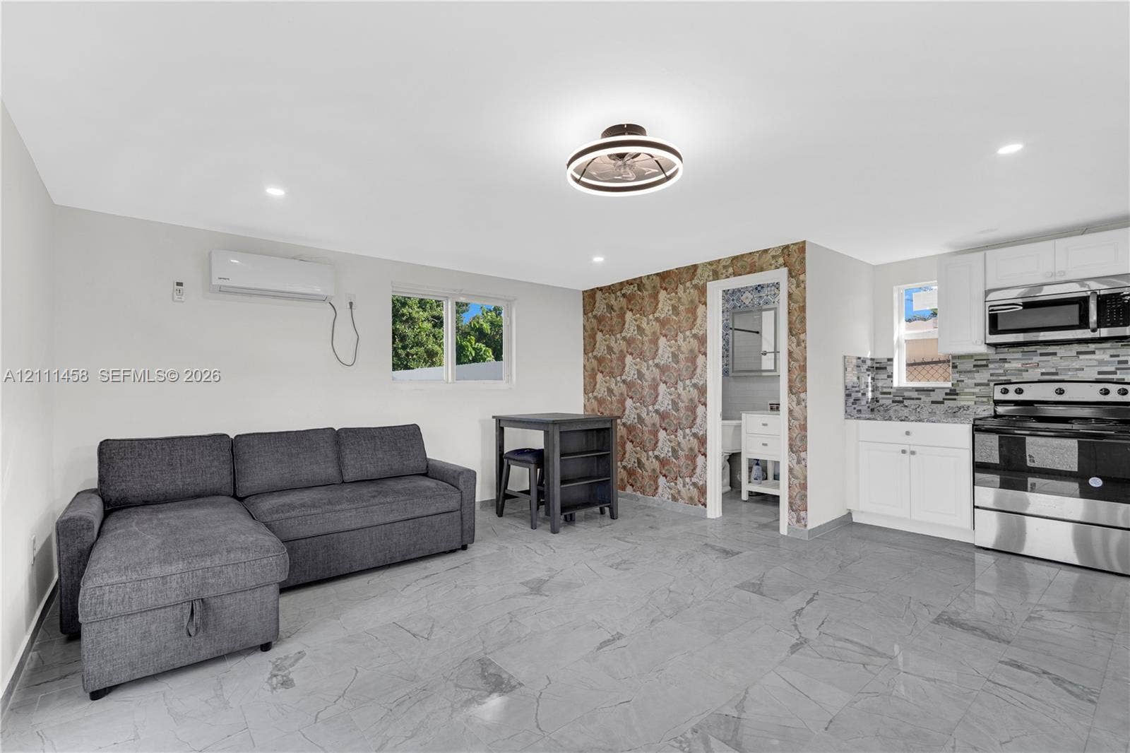 17135 NW 19th Avenue, Miami Gardens, FL 33056 Interior featuring a built-in kitchen with white cabinetry and stainless steel appliances