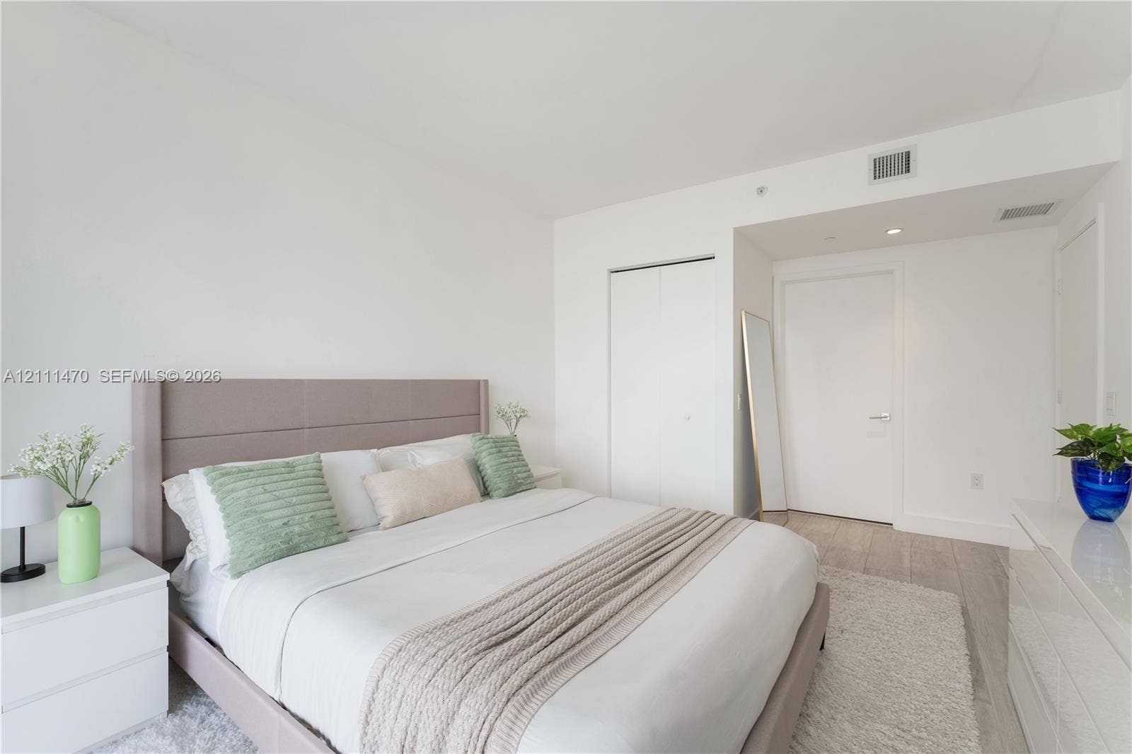 Interior space featuring neutral wall paint, wood-finish flooring, and recessed ceiling lighting