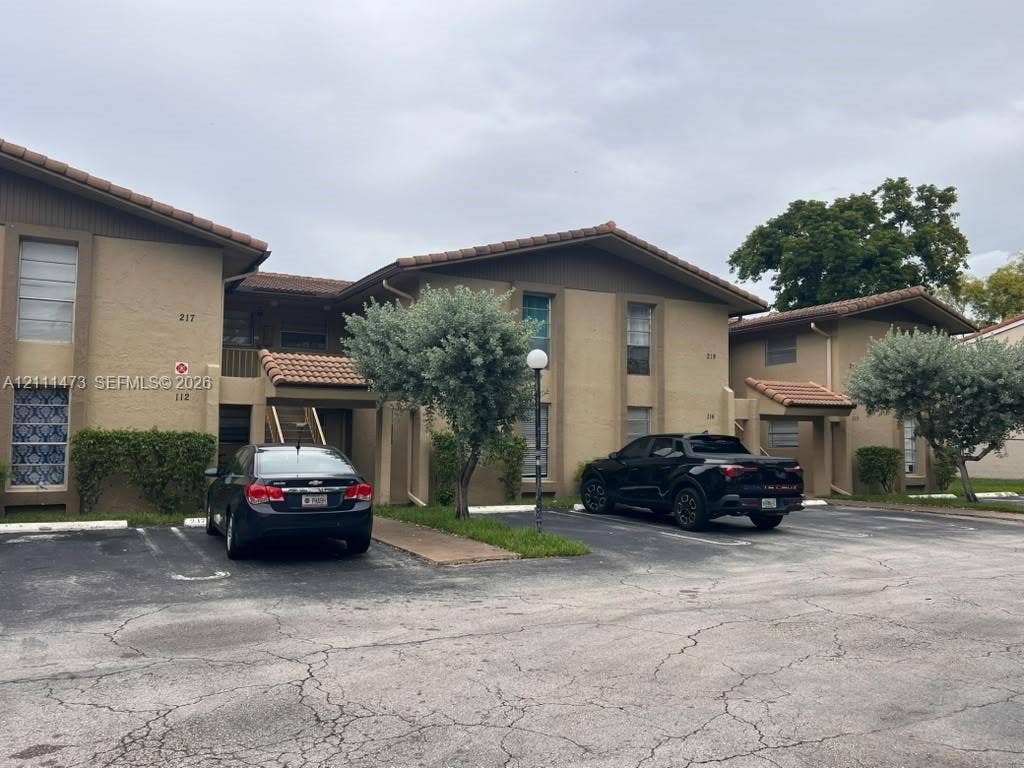 11101 Royal Palm Boulevard, #113, Coral Springs, Coral Springs, FL 33065 Multi-level stucco exterior with a tile roof and dedicated surface parking