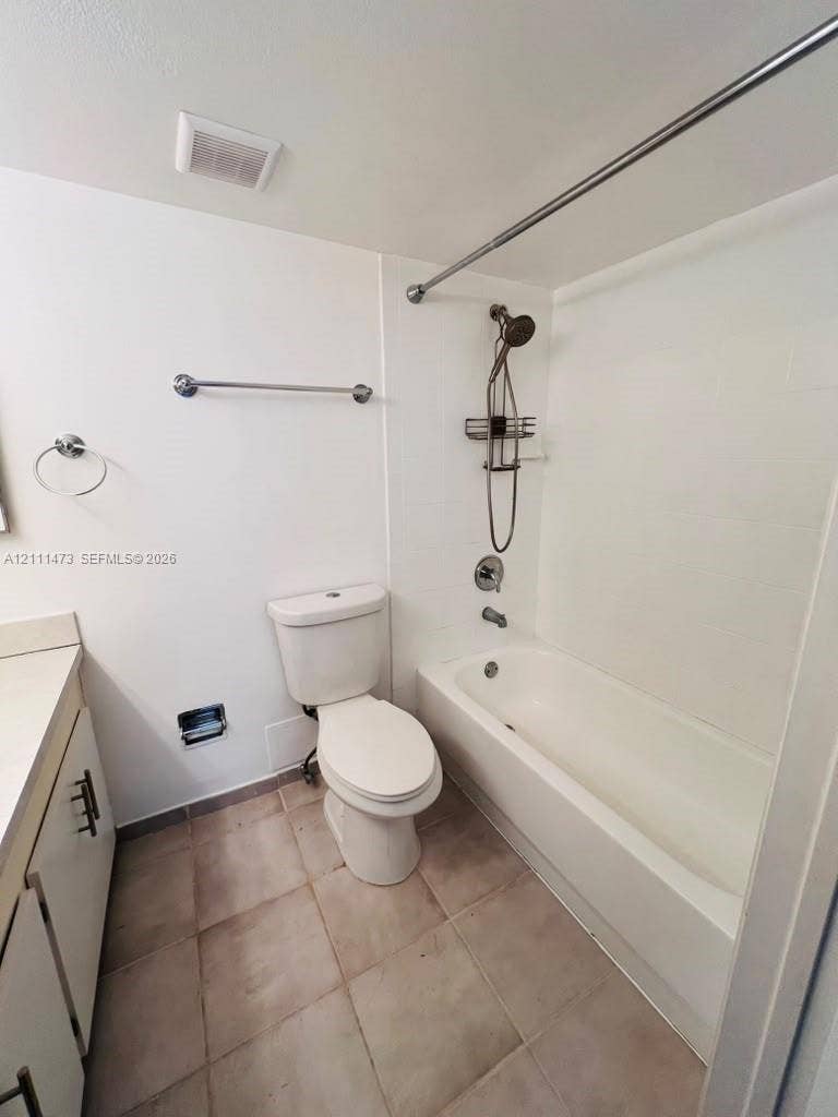 11101 Royal Palm Boulevard, #113, Coral Springs, Coral Springs, FL 33065 Bathroom featuring a shower-tub combination, a handheld showerhead, a neutral-toned tile floor, and a vanity with modern cabinet hardware