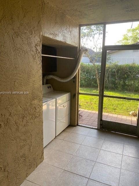 11101 Royal Palm Boulevard, #113, Coral Springs, Coral Springs, FL 33065 Screened-in enclosure with tile flooring and a dedicated laundry area featuring built-in shelving and exterior access