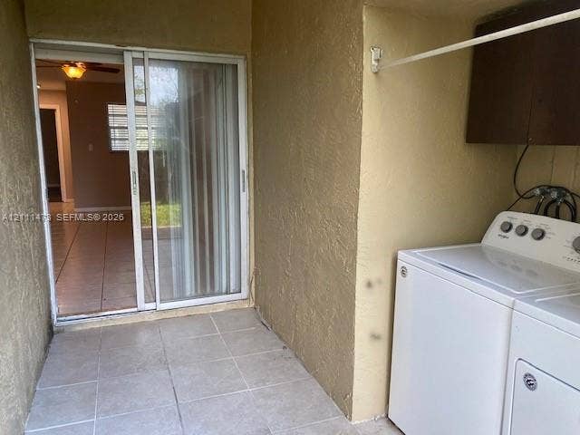 11101 Royal Palm Boulevard, #113, Coral Springs, Coral Springs, FL 33065 Covered outdoor utility area featuring ceramic tile flooring, sliding glass door entry, and wall-mounted cabinetry