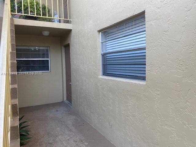 11101 Royal Palm Boulevard, #113, Coral Springs, Coral Springs, FL 33065 Stucco exterior finish with integrated stairwell, metal railing, and aluminum-frame windows