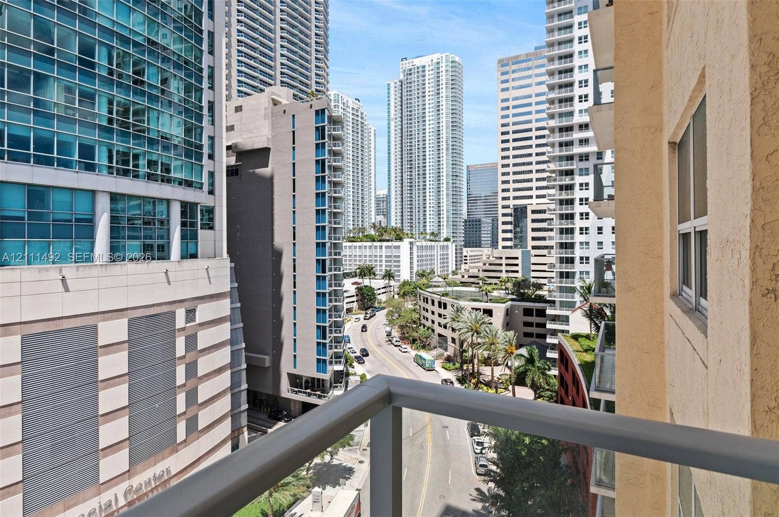 Balcony featuring a metal railing and urban landscape