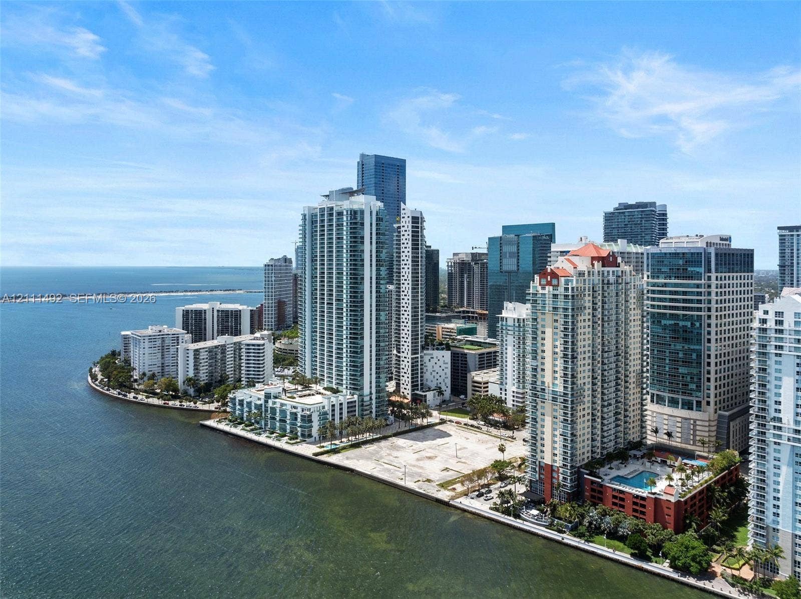 Aerial perspective of a high-rise residential district featuring extensive waterfront access, coastal panoramas, and dense urban infrastructure