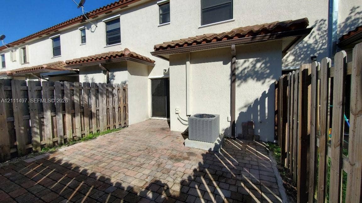 3210 SE 6th Street, Homestead, Homestead, FL 33033 Private rear patio featuring paver flooring and wood-style privacy fencing