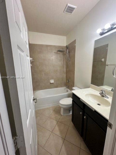 3210 SE 6th Street, Homestead, Homestead, FL 33033 Bathroom featuring a vanity with dark cabinetry and a light-toned countertop, a shower-tub combination with full-height tile surround, wall-mounted light fixture, and diagonal tile flooring