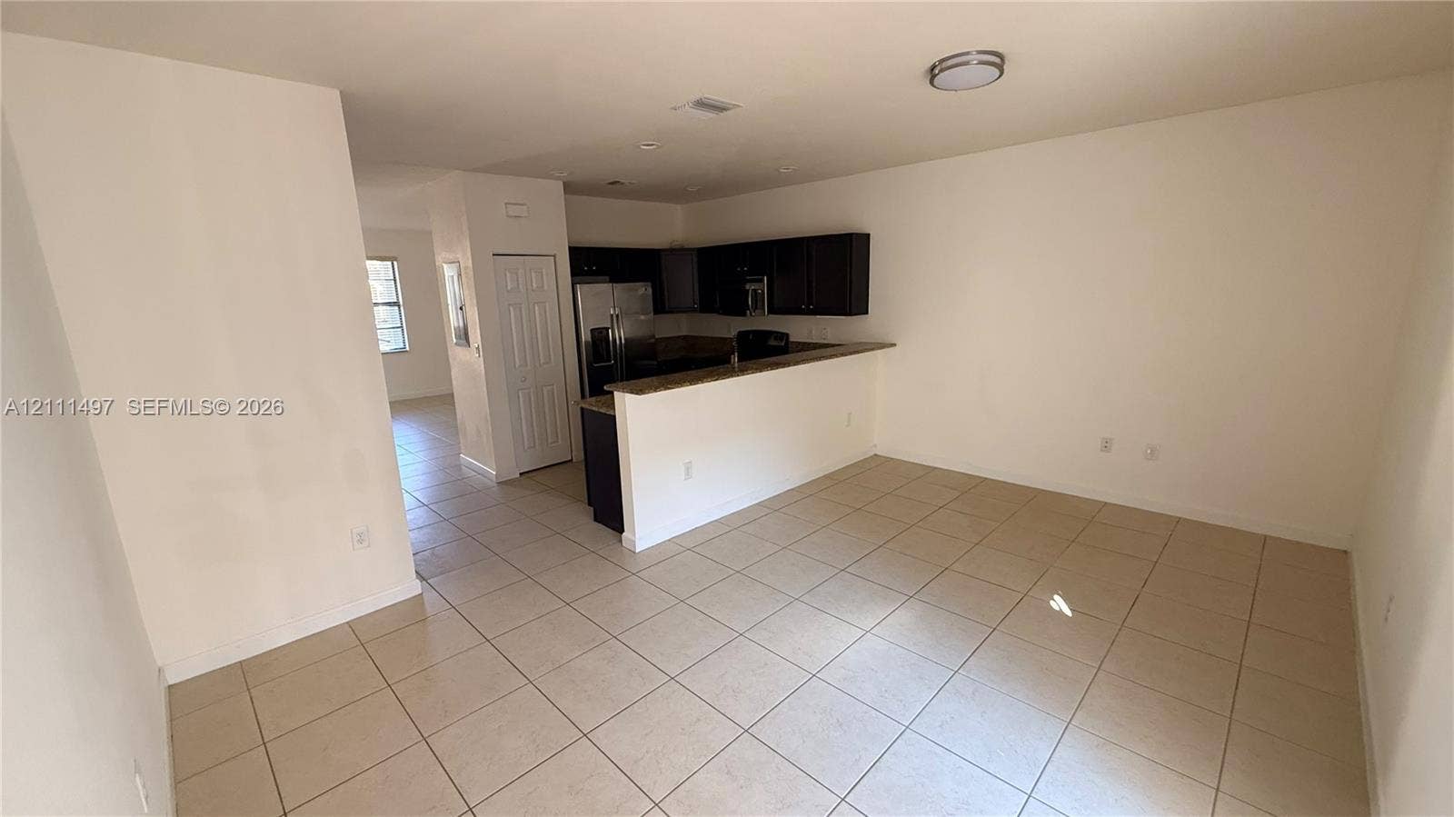 3210 SE 6th Street, Homestead, Homestead, FL 33033 Kitchen featuring dark cabinetry, stone-finish countertops, stainless steel appliances, and tile flooring
