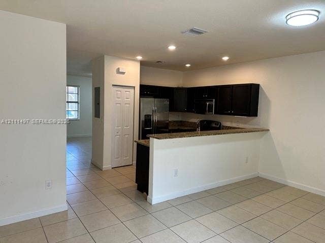 3210 SE 6th Street, Homestead, Homestead, FL 33033 Kitchen featuring dark cabinetry, stone-finish countertops, stainless steel appliances, a breakfast bar, and tile flooring