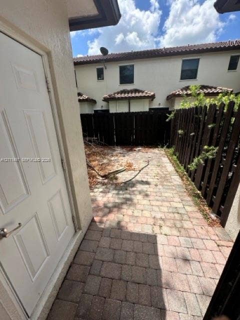 3210 SE 6th Street, Homestead, Homestead, FL 33033 Private outdoor patio featuring concrete paver flooring and wood privacy fencing