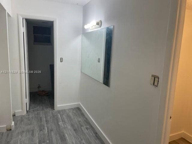 406 NW 68th Avenue, #118, Plantation, Plantation, FL 33317 Neutral-toned wood-finish flooring, wall-mounted vanity mirror, and four-bulb vanity lighting fixture