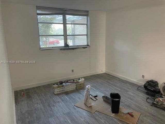 406 NW 68th Avenue, #118, Plantation, Plantation, FL 33317 Room featuring wood-finish flooring and a multi-pane horizontal window