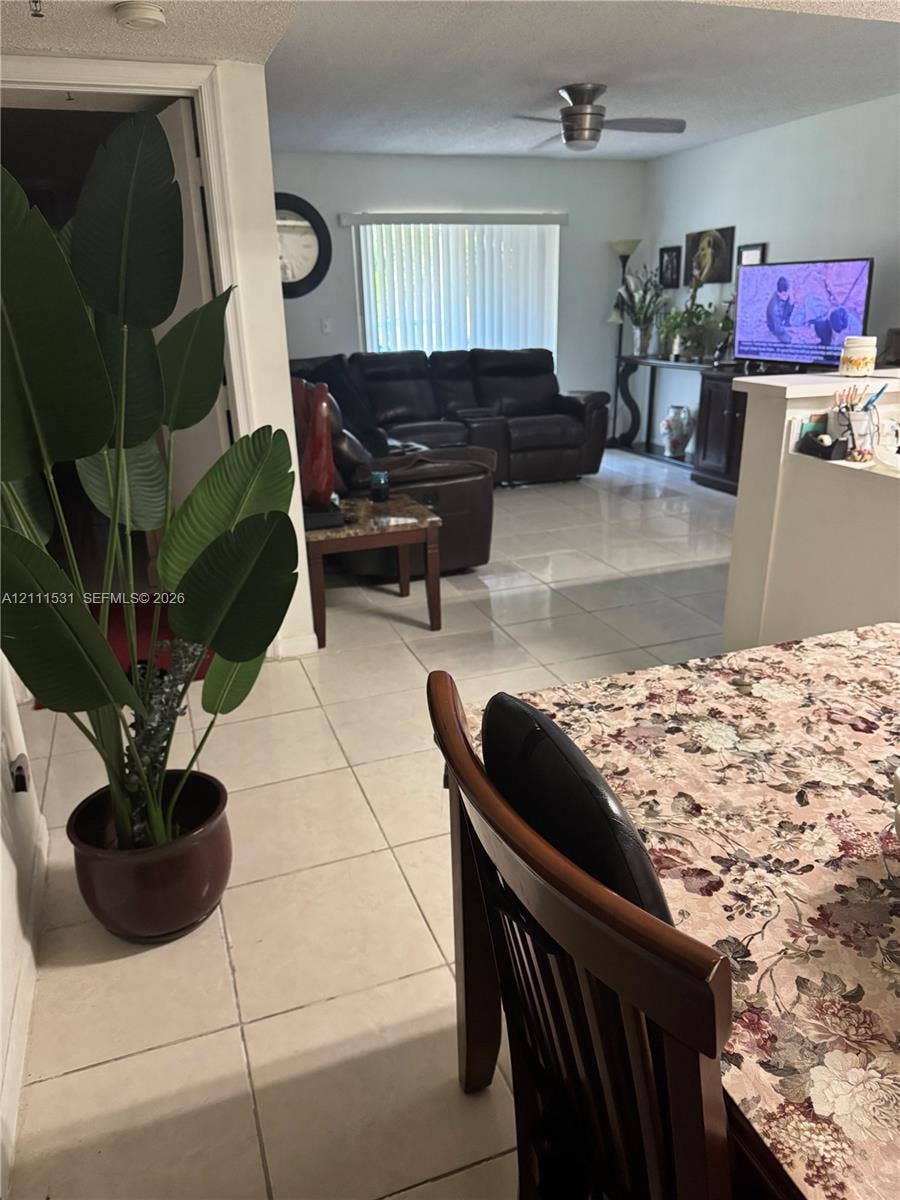 5550 NW 61st Street, #507, Coconut Creek, Coconut Creek, FL 33073 Large-format tile flooring, ceiling-mounted fan, and vertical blind window treatments