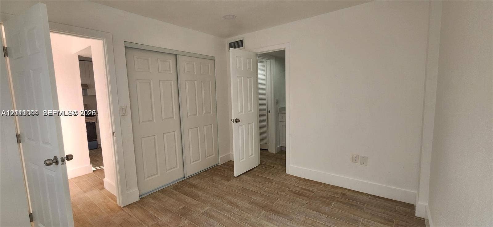 19771 SW 114th Avenue, #227, Miami, Miami, FL 33157 Interior space featuring wood-finish flooring, two sets of panel doors, and recessed lighting