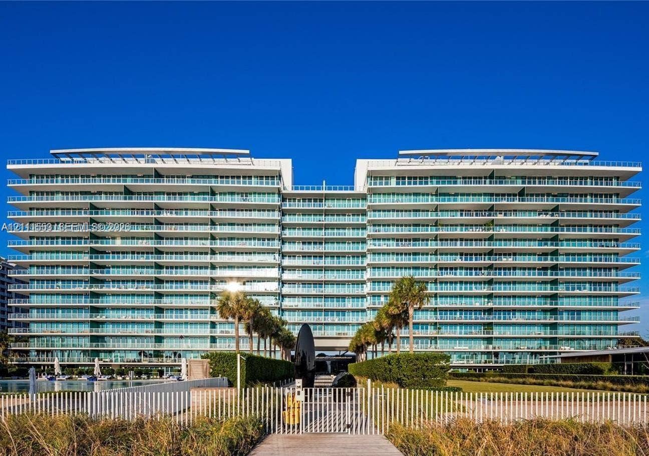 Modern mid-rise structure featuring floor-to-ceiling glass windows, full-length private balconies, contemporary architectural lines, and landscaped grounds