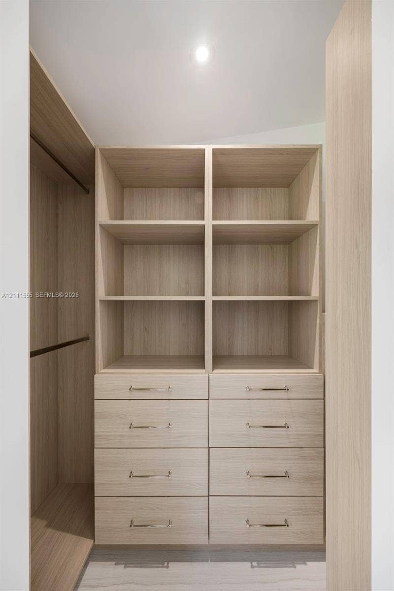 8800 SW 118th Street, Miami, Miami, FL 33176 Built-in storage system featuring wood-finish cabinetry, integrated open shelving, double columns of drawers, and metal hardware