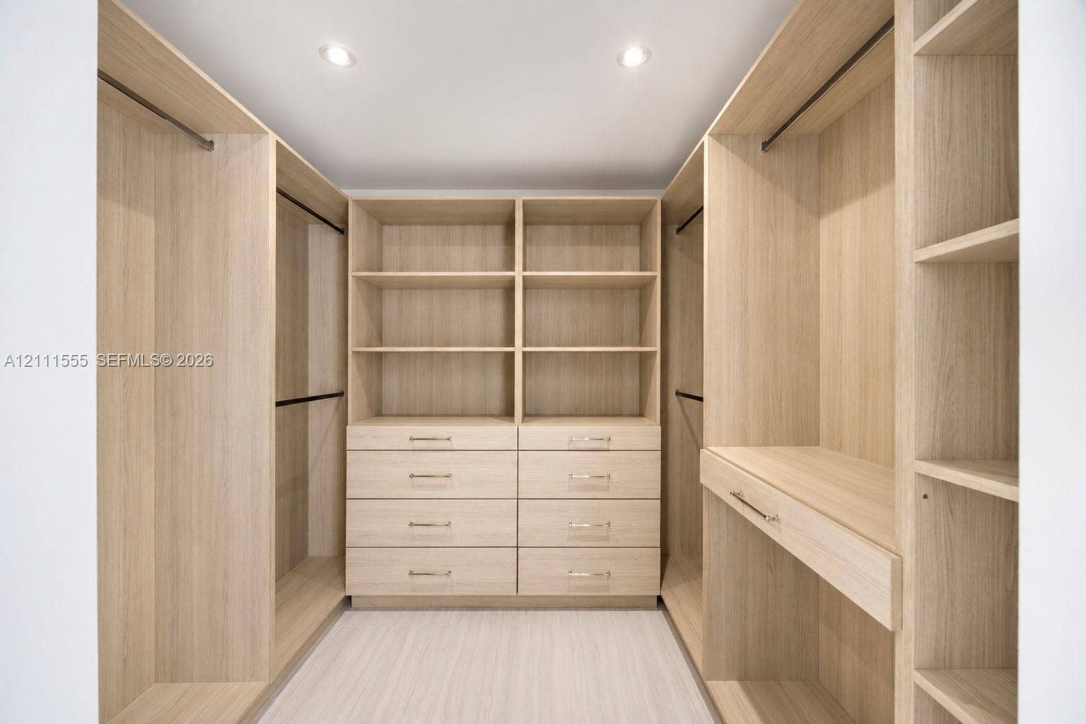 8800 SW 118th Street, Miami, Miami, FL 33176 Primary Closet - His Custom wood-finish cabinetry featuring integrated shelving, dual hanging rods, built-in dresser drawers with metallic hardware, and recessed ceiling lighting
